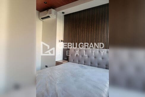 Pacific Grand Villa house for sale — modern staircase with textured stone accent wall