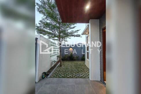 Pacific Grand Villa house for sale — modern kitchen with white cabinets and dining set