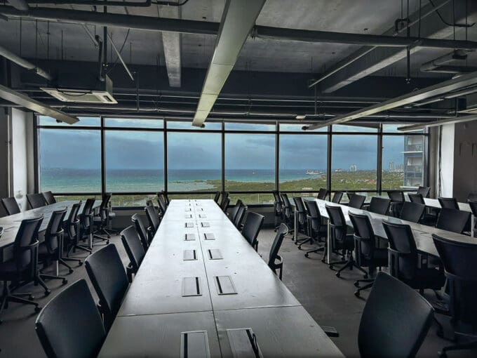 Whole floor office with rows of workstations and sea views through the perimeter glazing at the PEZA office for rent in Mactan Newtown, Lapu-Lapu