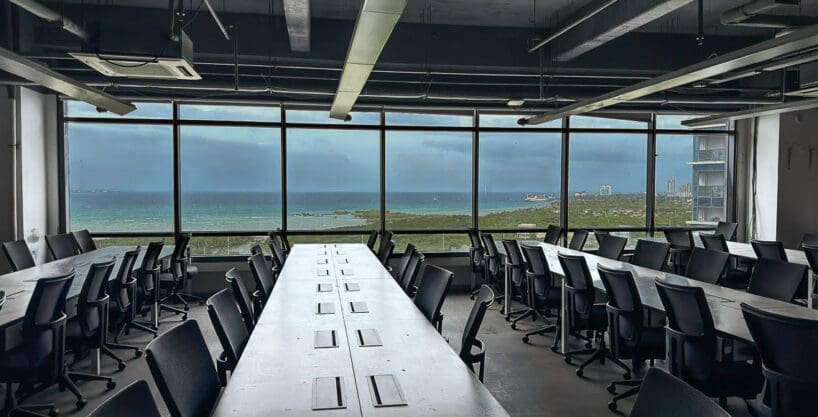 Whole floor office with rows of workstations and sea views through the perimeter glazing at the PEZA office for rent in Mactan Newtown, Lapu-Lapu
