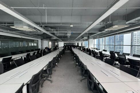 Workstation aisle with VRF ceiling cassettes and township views at the 2011 sqm PEZA office for rent in Mactan Newtown