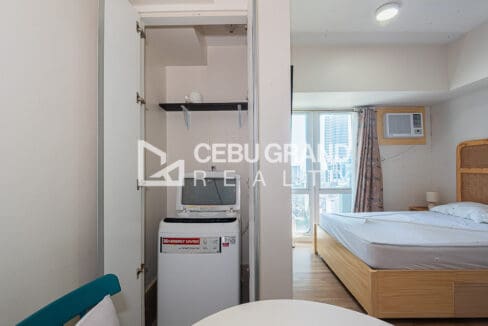 Washing machine in its own closet beside the sleeping area at the studio for rent at Solinea Tower 2