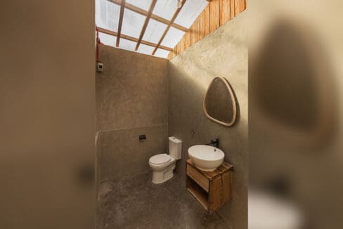Guest bathroom with toilet and basin at the resort for sale in Oslob, Cebu
