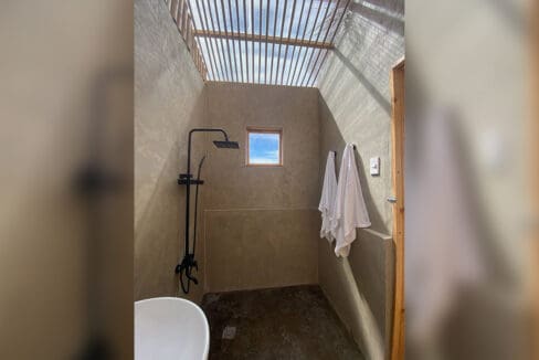 Walk-in shower with rain head and towels at the resort for sale in Oslob, Cebu