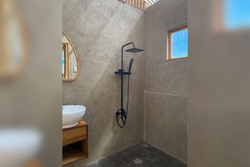 Shower and vanity in a guest bathroom at the resort for sale in Oslob, Cebu