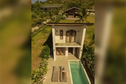 Two-storey villa with private infinity pool and sun loungers at the resort for sale in Oslob, Cebu