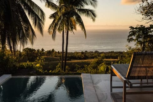 Sunset over the sea from the villa infinity pool at the resort for sale in Oslob, Cebu