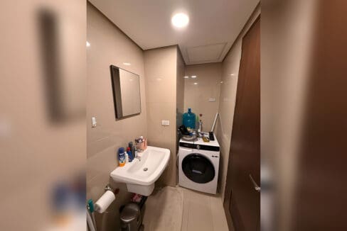 Utility area with washer, vanity and mirror