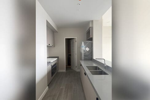 Galley kitchen with built-in cabinets and counter at Aruga Residences, Mactan