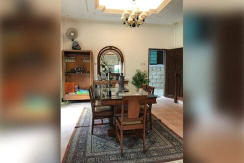 Dining area with wooden table and display cabinet at the house and lot for sale in Maghaway, Talisay