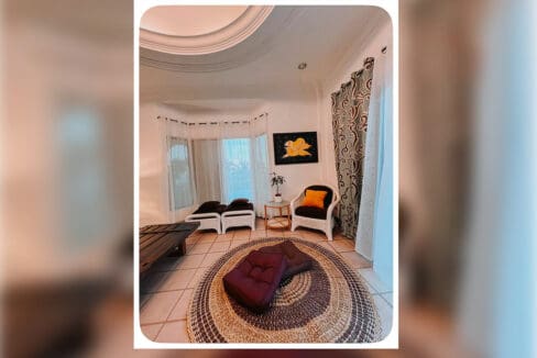 Living area seating with framed artwork at the 6BR house and lot for sale in Maghaway, Talisay