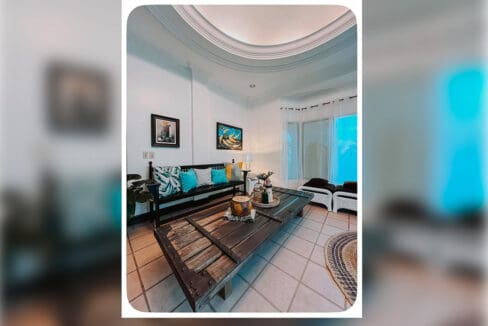 Living room seating and low wooden table at the house and lot for sale in Maghaway, Talisay