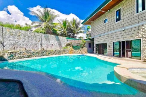 Swimming pool with attached jacuzzi and stone boundary wall at the house and lot for sale in Maghaway, Talisay