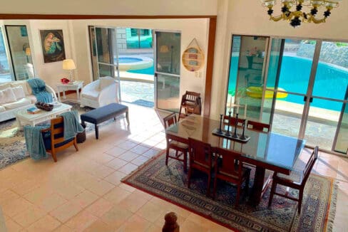 Living and dining area opening through sliding doors to the swimming pool at the house and lot for sale in Maghaway, Talisay