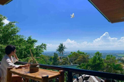View over Talisay to the sea from a covered balcony at the 6BR house and lot for sale in Maghaway, Talisay