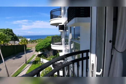 Sea view from the curved private balcony at the furnished 1BR condo for sale in Boracay, Oceanway Residences