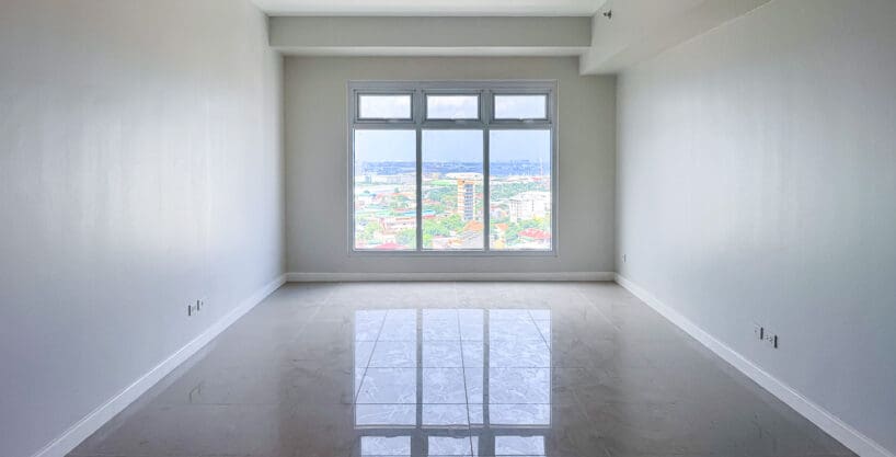 Bedroom with full-height window and city view at the 2 bedroom corner condo for sale at Sedona Parc