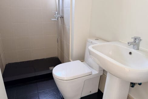 Bathroom with walk-in shower and pedestal basin at the 2 bedroom condo for sale at Sedona Parc