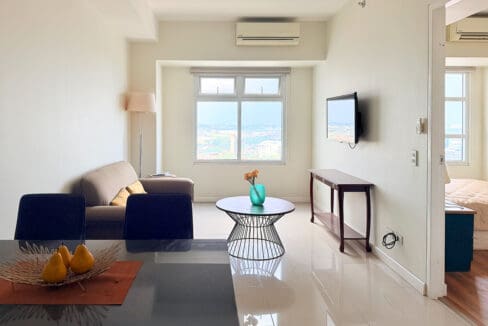 Open-plan living room with city views in the 50 sqm Sedona Parc condo on the 22nd floor