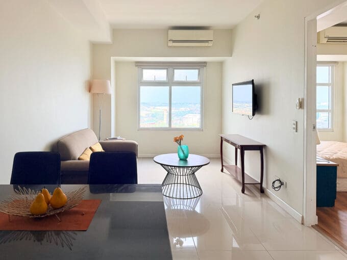 Open-plan living room with city views in the 50 sqm Sedona Parc condo on the 22nd floor
