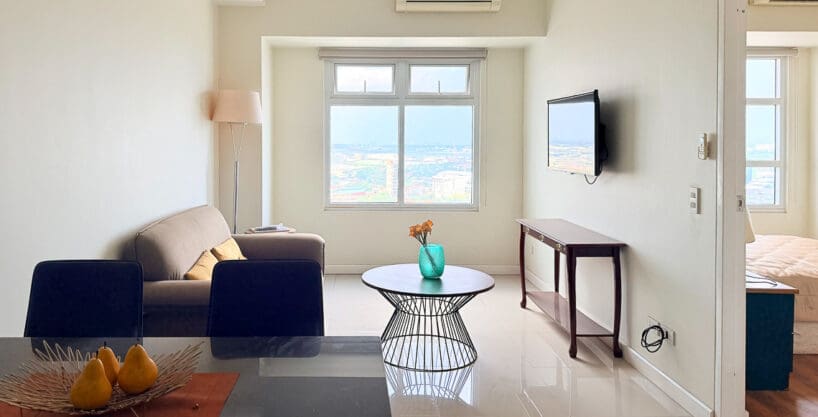 Open-plan living room with city views in the 50 sqm Sedona Parc condo on the 22nd floor