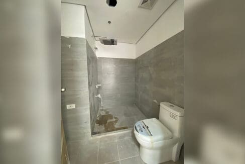 Bathroom finished in full-height tile with a walk-in shower area