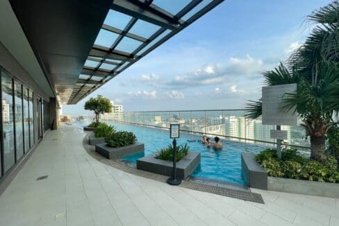 Rooftop pool deck with landscaped planters and sea view