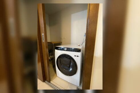 Enclosed laundry area with front-load washing machine