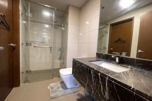 Bathroom with glass shower enclosure and marble vanity