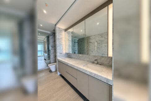 Master ensuite vanity with marble counter and mirrored cabinets