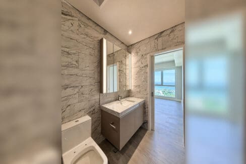 Marble bathroom with vanity opening to the bedroom