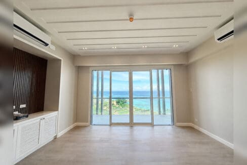 Living area with slatted timber feature wall and floor-to-ceiling sea view