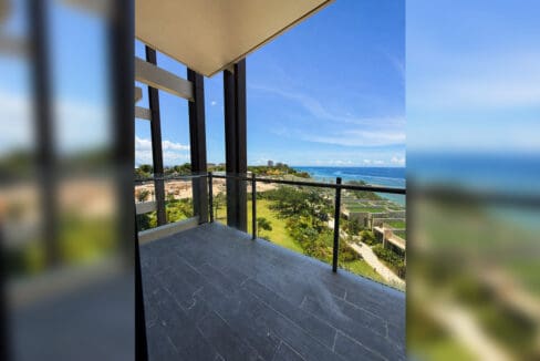 Private balcony with glass railing overlooking the sea