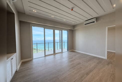 Living area with sliding doors opening to the balcony and the sea