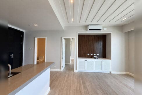 Living area with built-in media cabinet and powder room off the entry