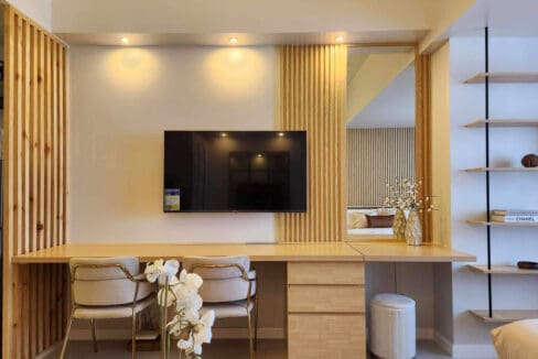 Solid-wood workspace and dining counter beneath the wall-mounted television