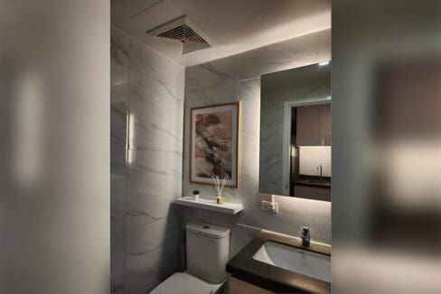Bathroom vanity with LED mirror and marble-look tiling