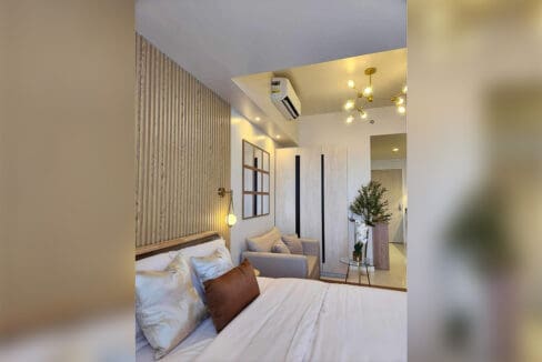 View from the bed toward the wardrobes and entry of the 30 sqm studio