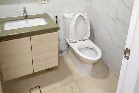 Bathroom with vanity cabinet, toilet and bidet spray
