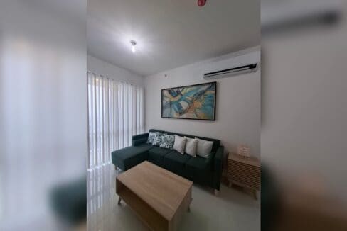 Living area with split-type air conditioning and vertical blinds to the balcony.