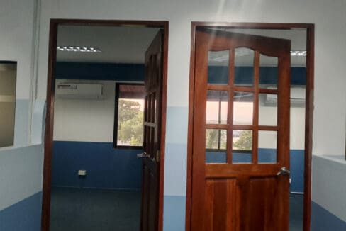 Two timber-framed doors leading to the manager and supervisor offices with sea views