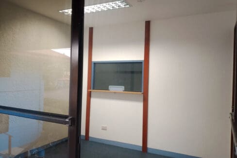 Reception window and counter by the glazed entrance door of the office