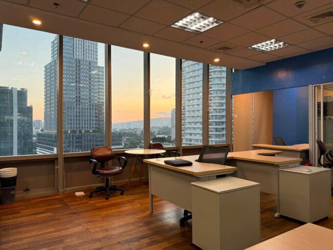 Semi furnished office for rent in Park Centrale, Cebu IT Park, with the corner window wall looking over the IT Park towers at sunset