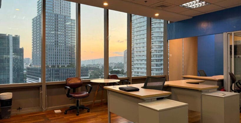 Semi furnished office for rent in Park Centrale, Cebu IT Park, with the corner window wall looking over the IT Park towers at sunset