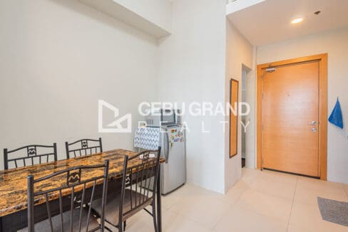 Dining table, refrigerator and microwave near the entry door