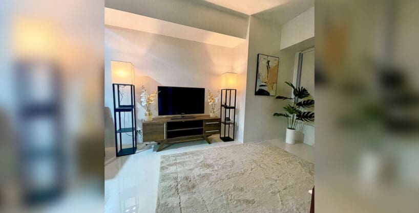 Living area with TV console in a brand-new furnished 1BR condo for rent at Taft East Gate, Mabolo, Cebu City