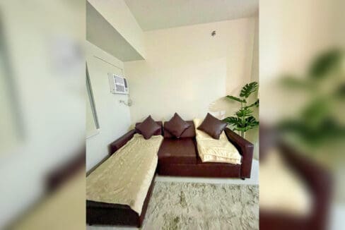 Sofa bed in the living room of a brand-new 1BR condo unit