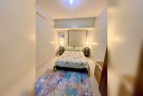 Bedroom with bed in a brand-new furnished 1BR condo for rent