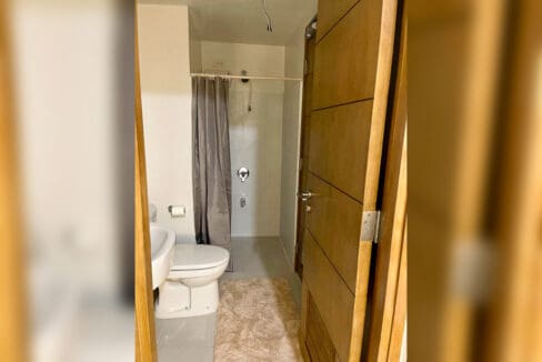Bathroom shower area in a brand-new 1-bedroom condo