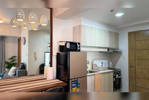 Kitchen with wood-grain cabinets, sink, range hood and cooking range with oven